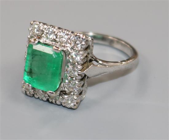 An 18ct white gold, emerald and diamond cluster tablet ring, size J.